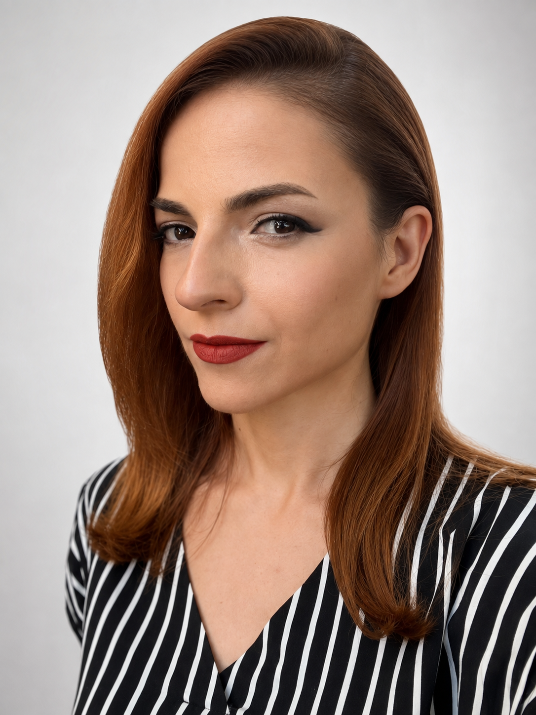 Portrait photo of Desislava Desseva, auburn hair, black-and-white striped top, cropped to a circle