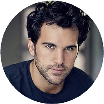 Circular headshot of a dark-haired man in a black top against a dark background